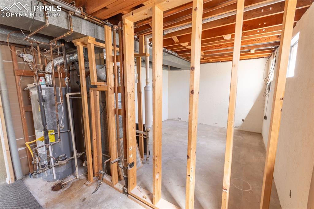 Below grade area featuring water heater