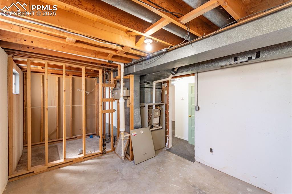 Unfinished below grade area with heating unit