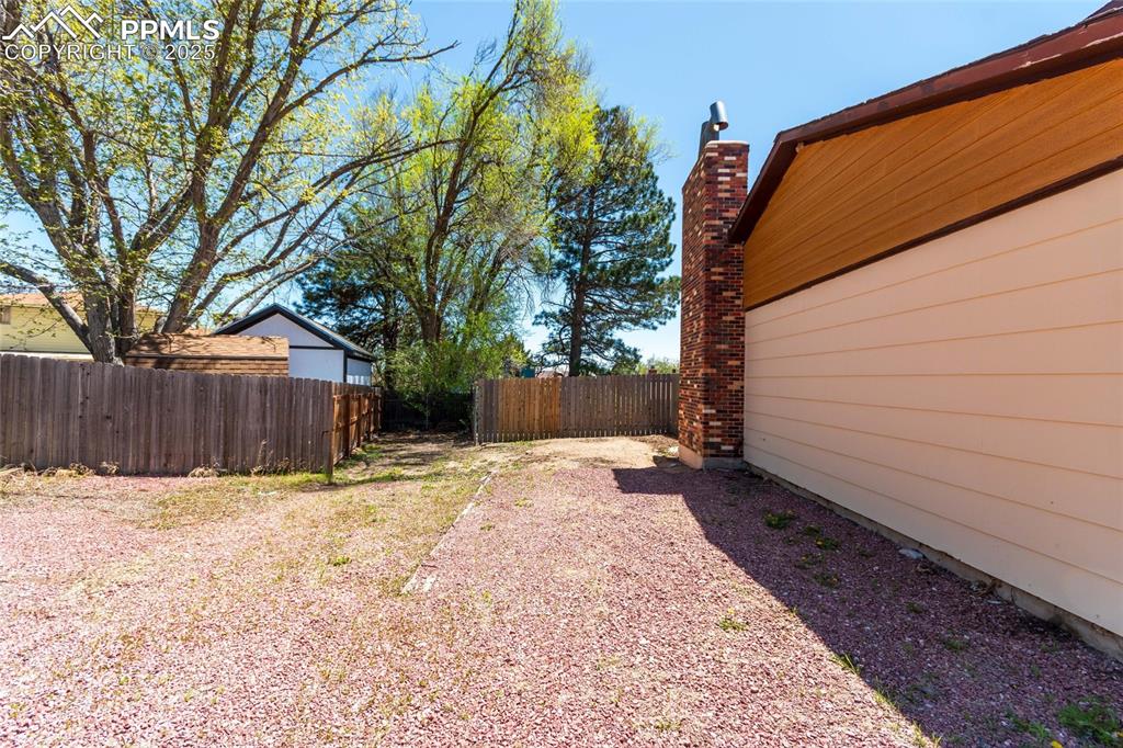 View of yard featuring fence