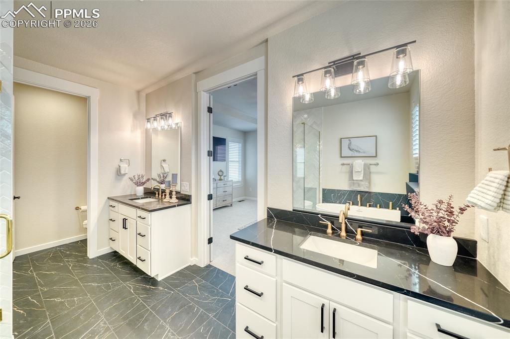 Bathroom featuring toilet and two vanities