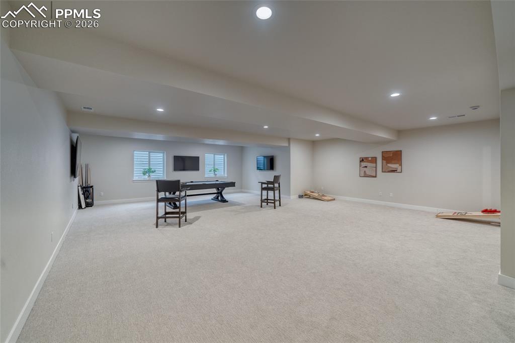 Rec room with light carpet and recessed lighting