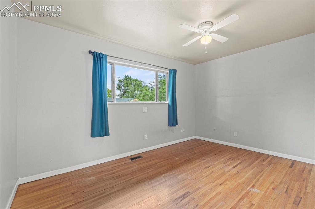 Spare room featuring hardwood / wood-style floors and ceiling fan