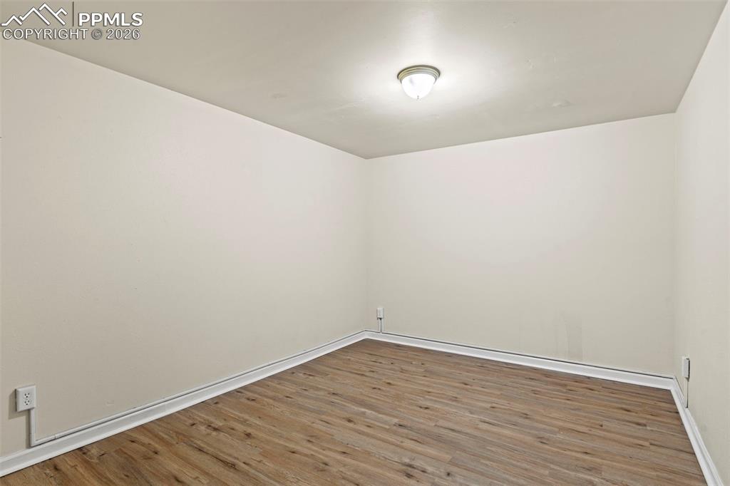Spare room with wood finished floors and baseboards