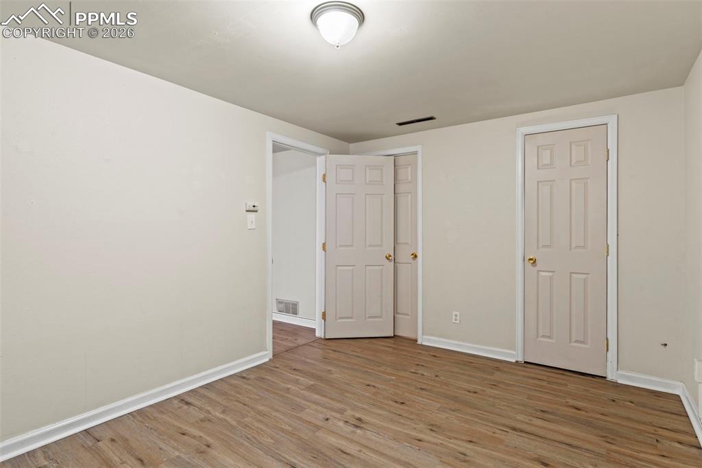 Unfurnished bedroom with light wood finished floors and a closet