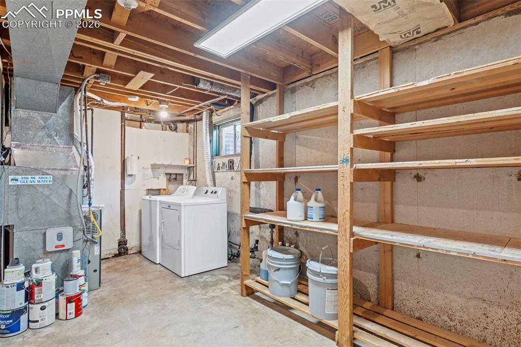 Below grade area with separate washer and dryer and heating unit