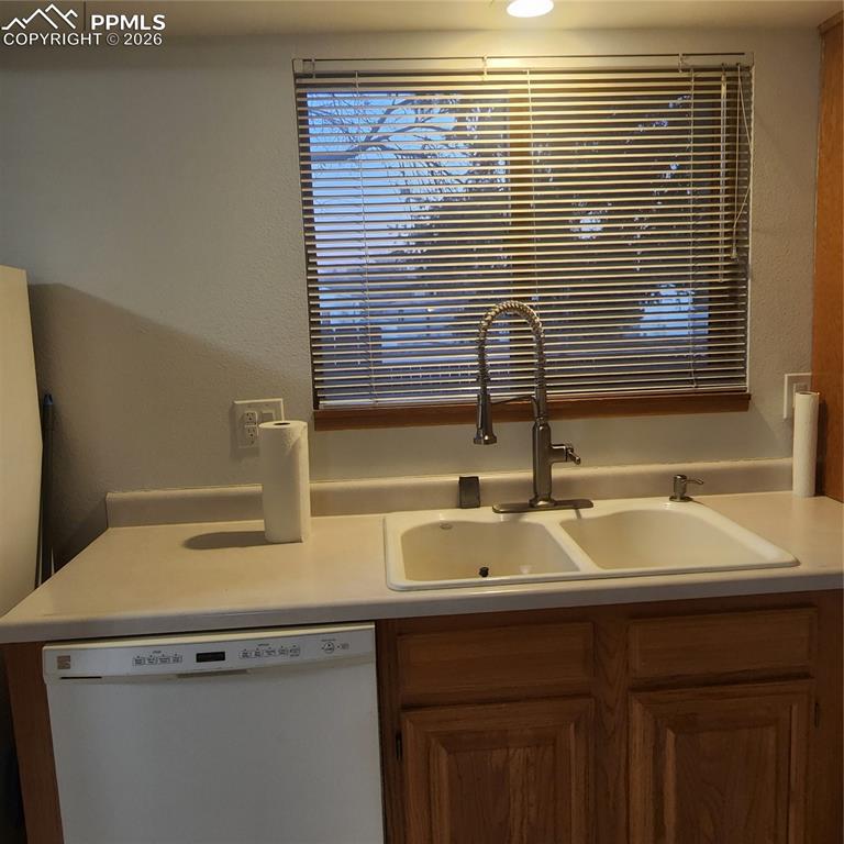 refrigerator, dishwaher, and window that overlooks courtyard