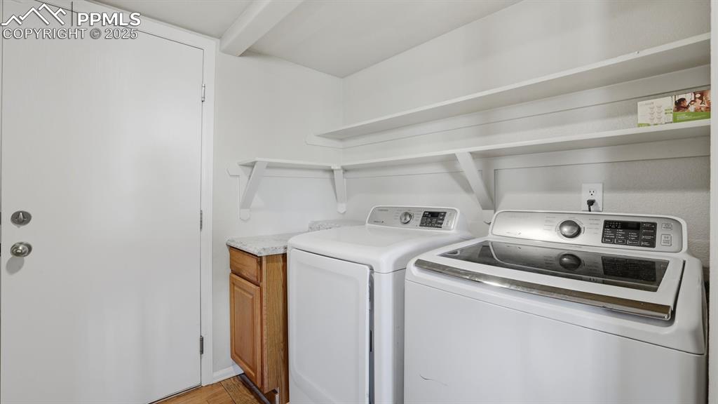 The Laundry Room has garage access, built-in shelves, cabinet, and washer and dryer.
