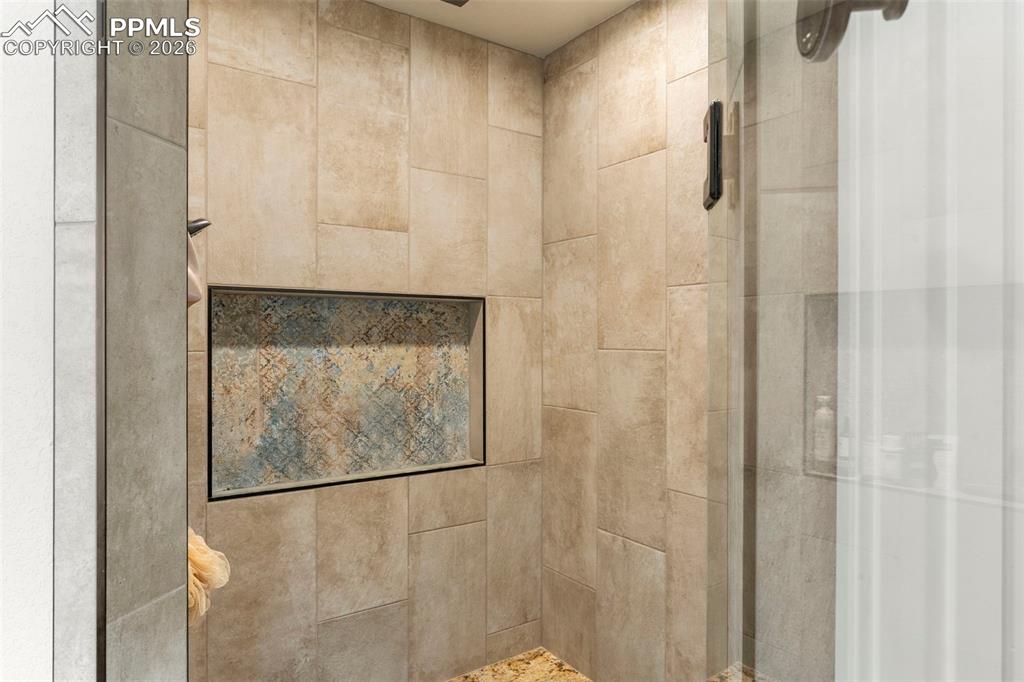 Tile shower with bench and glass door
