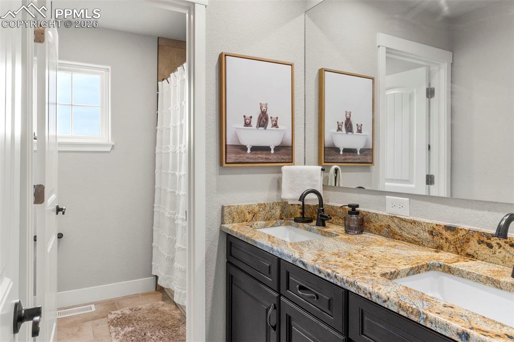 Double sink granite vanities in both primary baths