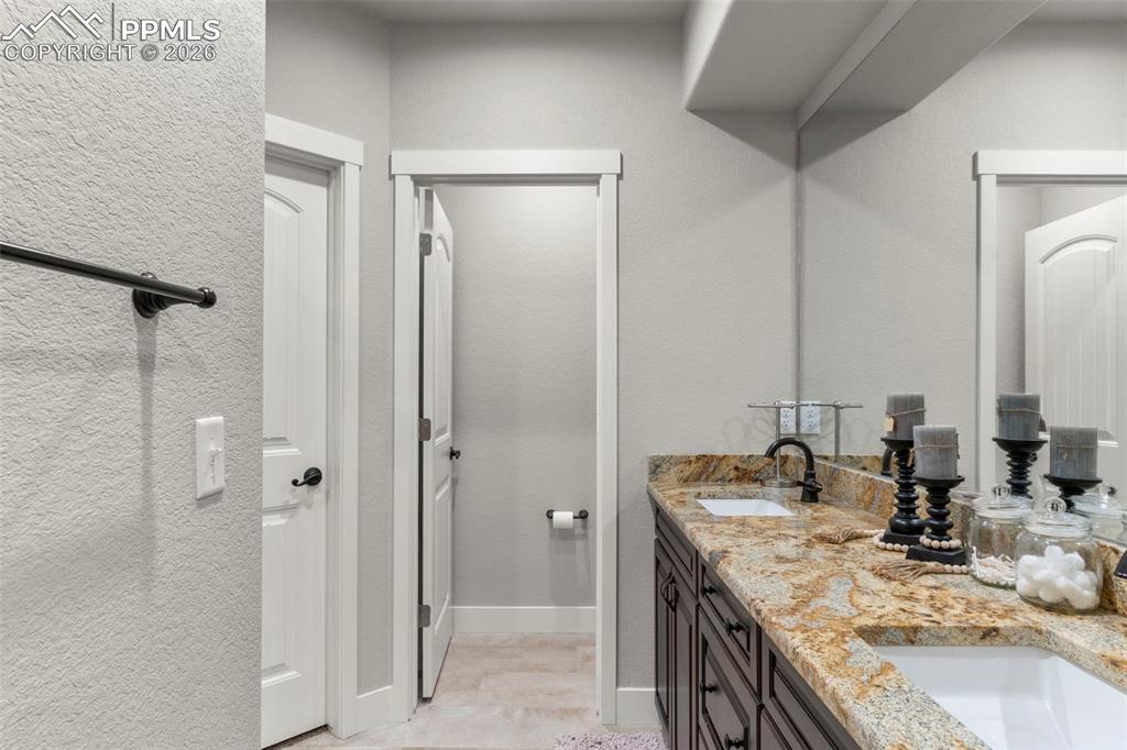 Double sink granite vanities in both primary baths