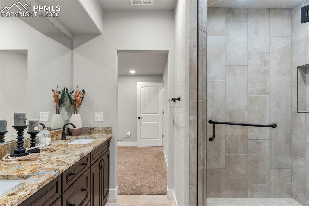Tile shower with bench and glass door