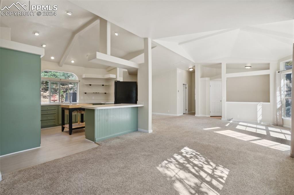 Living room featuring light carpet and lofted ceiling
