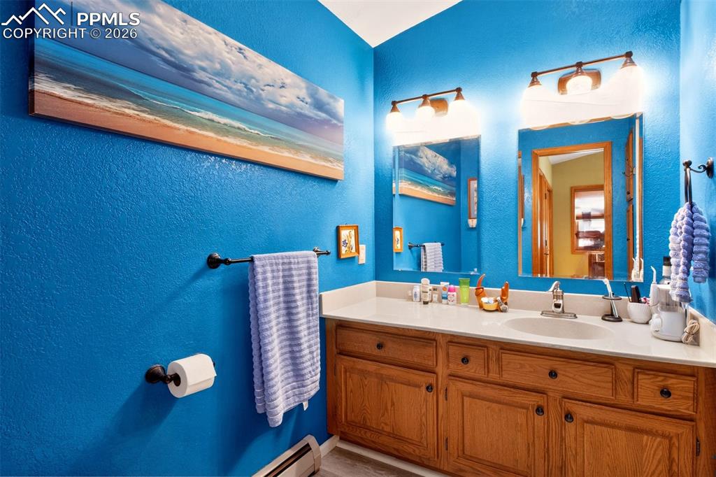 Primary en suite bathroom with stand in shower and a skylight for plenty of natural light