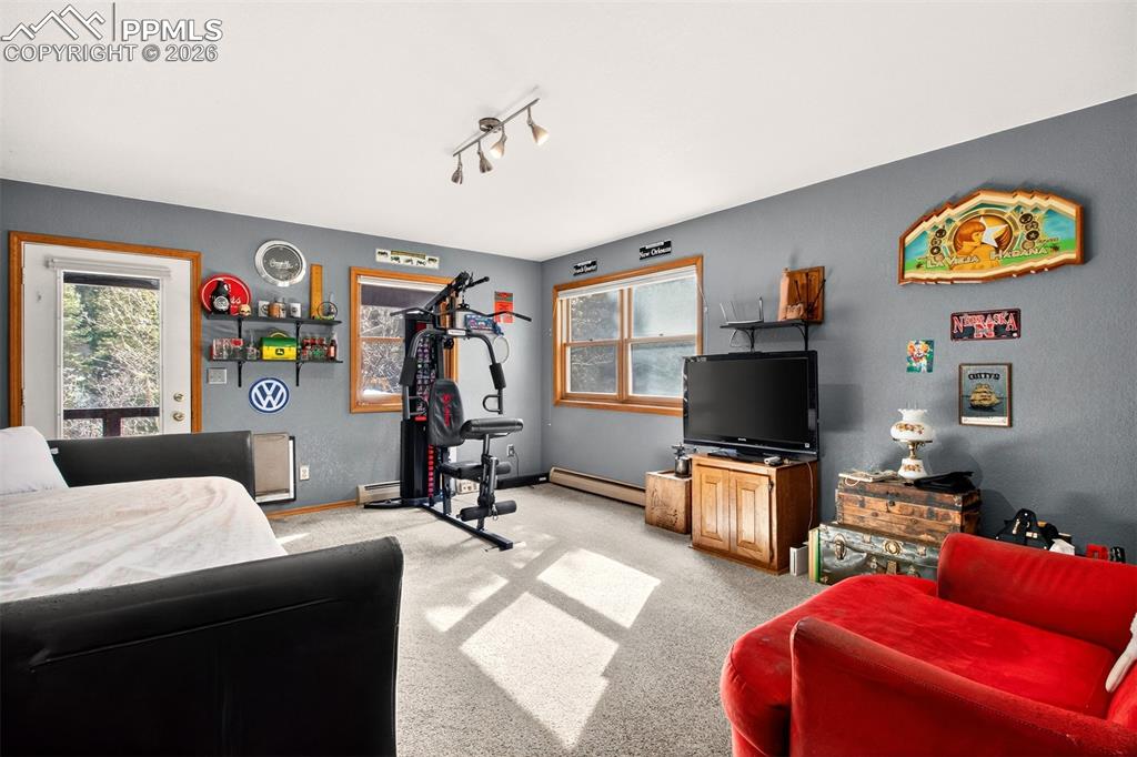 Family room with walk out to covered lower deck with hot tub and dog run