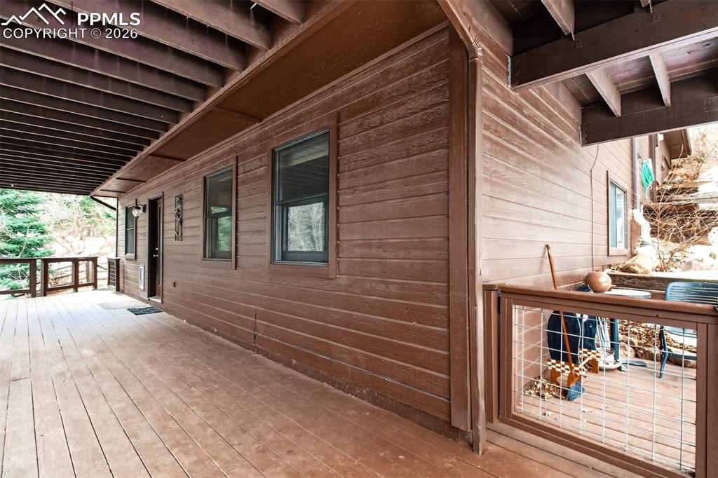 Lower level covered deck with hot tub and dog run