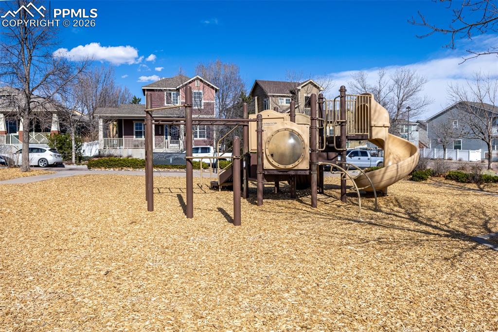 Community jungle gym with a residential view