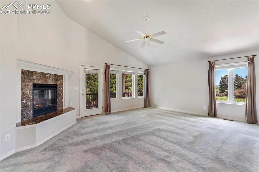 Living room has vaulted ceilings and gas fireplace