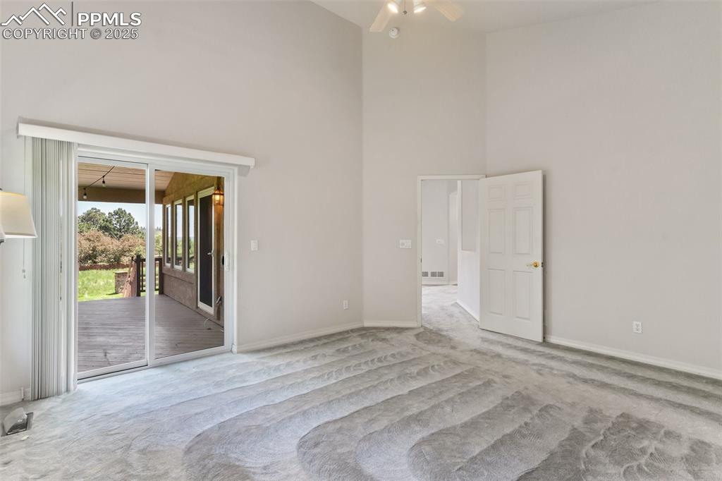 Large primary bedroom with walkout to deck , large walk in closet and 5 piece bath