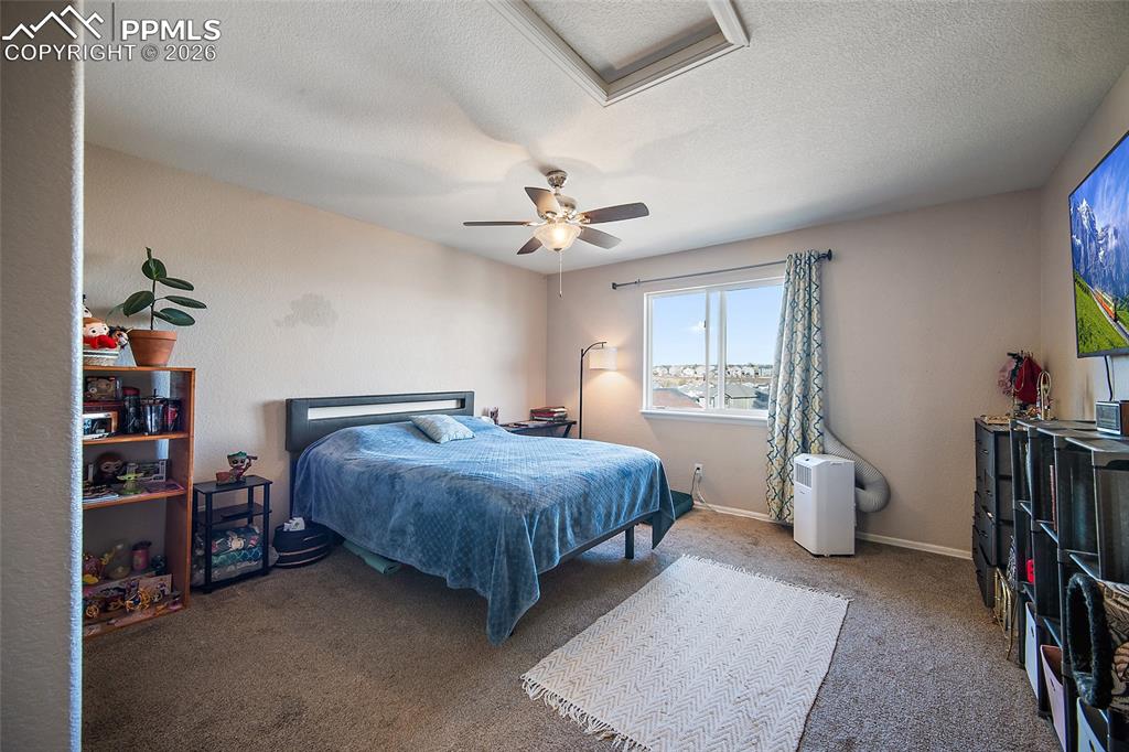 Primary bedroom with a ceiling fan