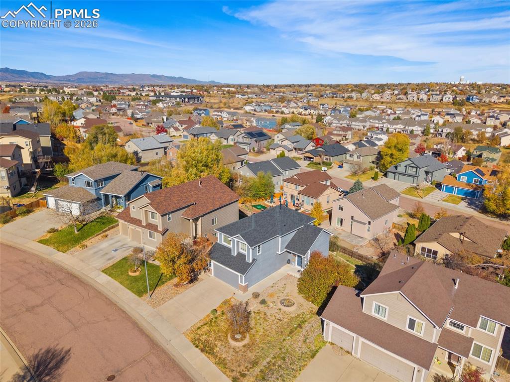 Aerial view of residential area featuring mountains