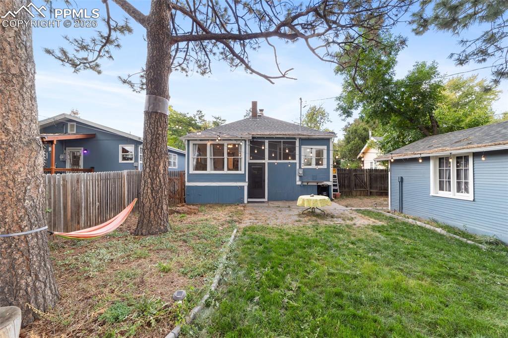 Rear view of property with a fenced backyard