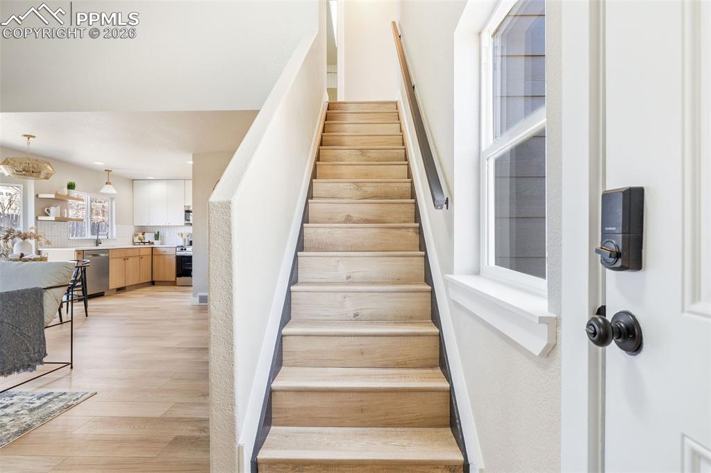 Staircase featuring wood finished floors