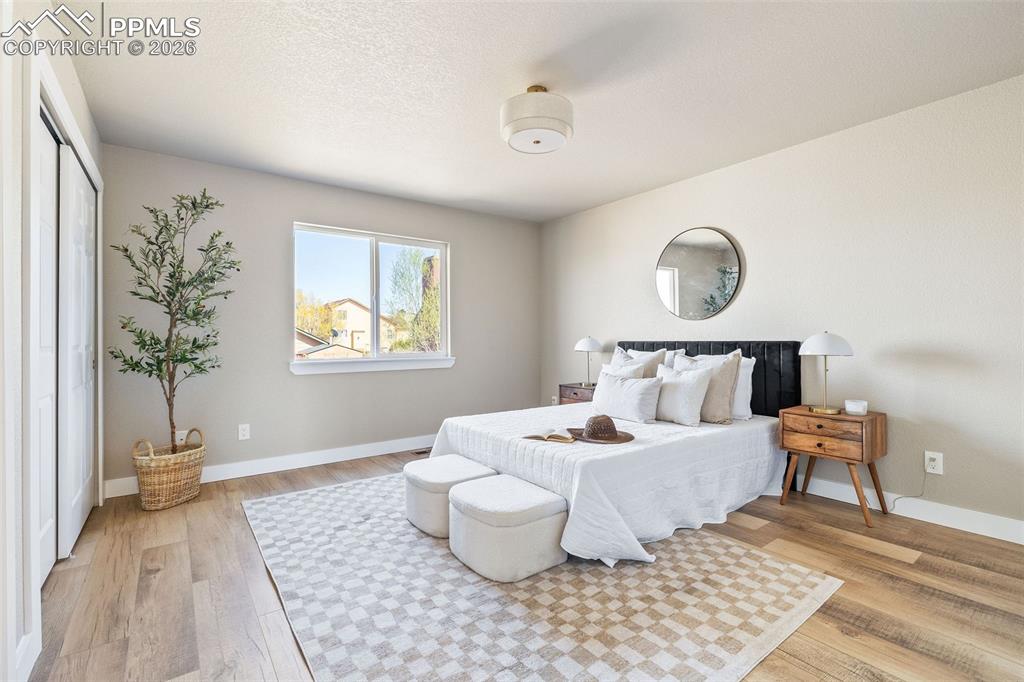 Bedroom with light wood-style flooring and baseboards