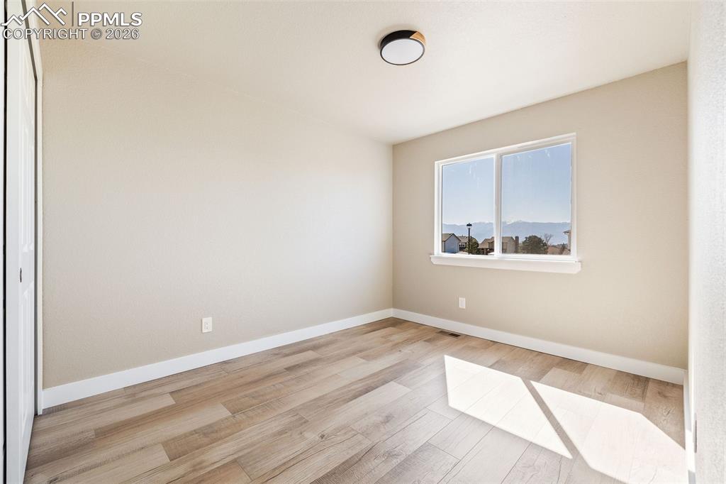 Spare room with light wood finished floors and baseboards