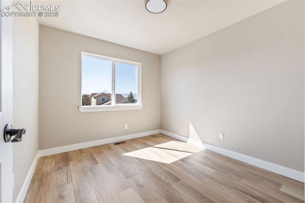 Empty room featuring light wood-style floors and baseboards