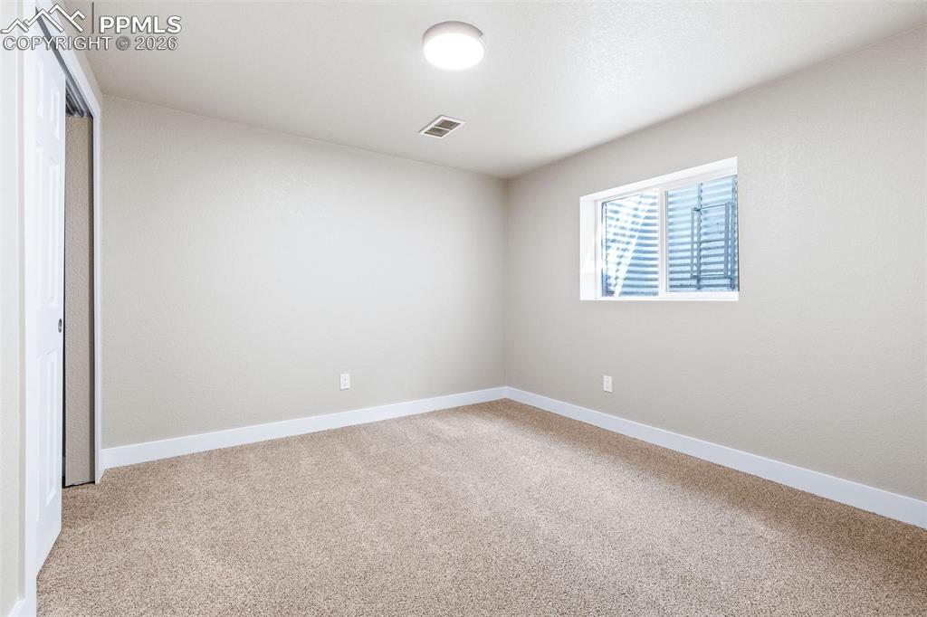 Unfurnished bedroom with a closet and light carpet