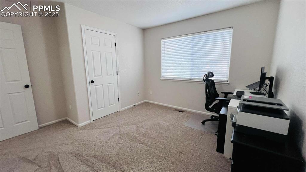 Carpeted home office with baseboards