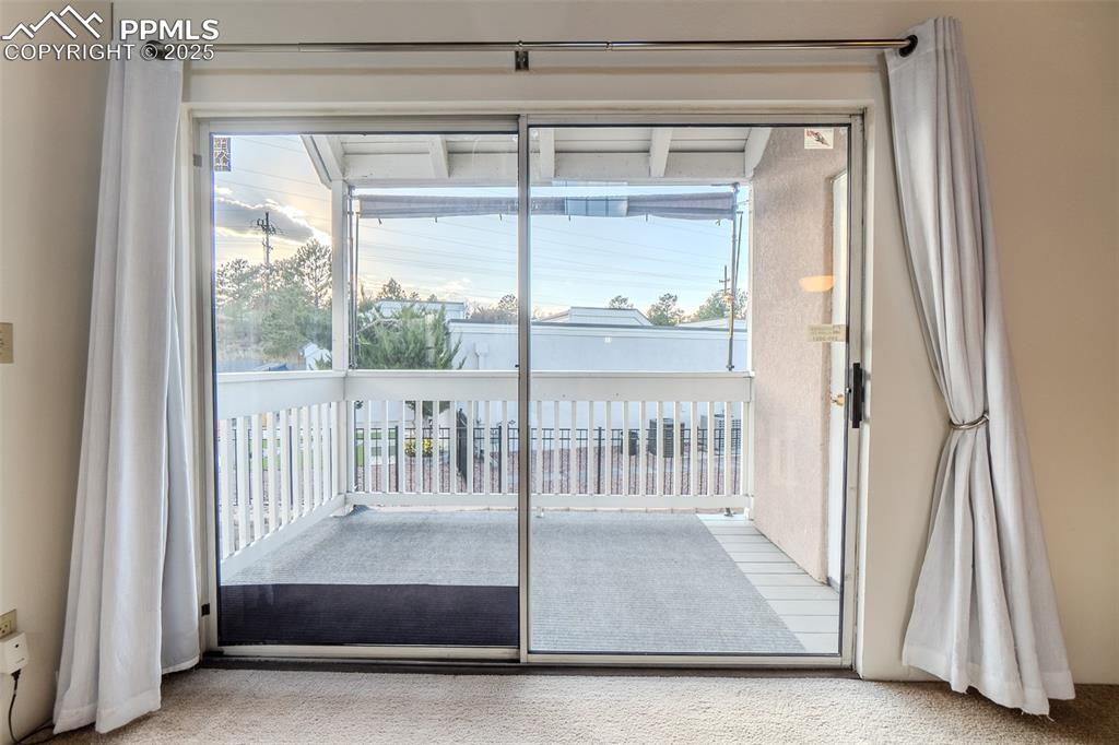 Doorway featuring carpet flooring