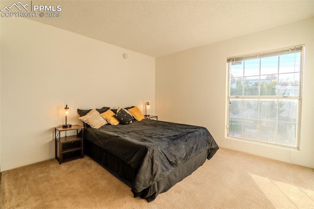 Carpeted bedroom with a textured ceiling