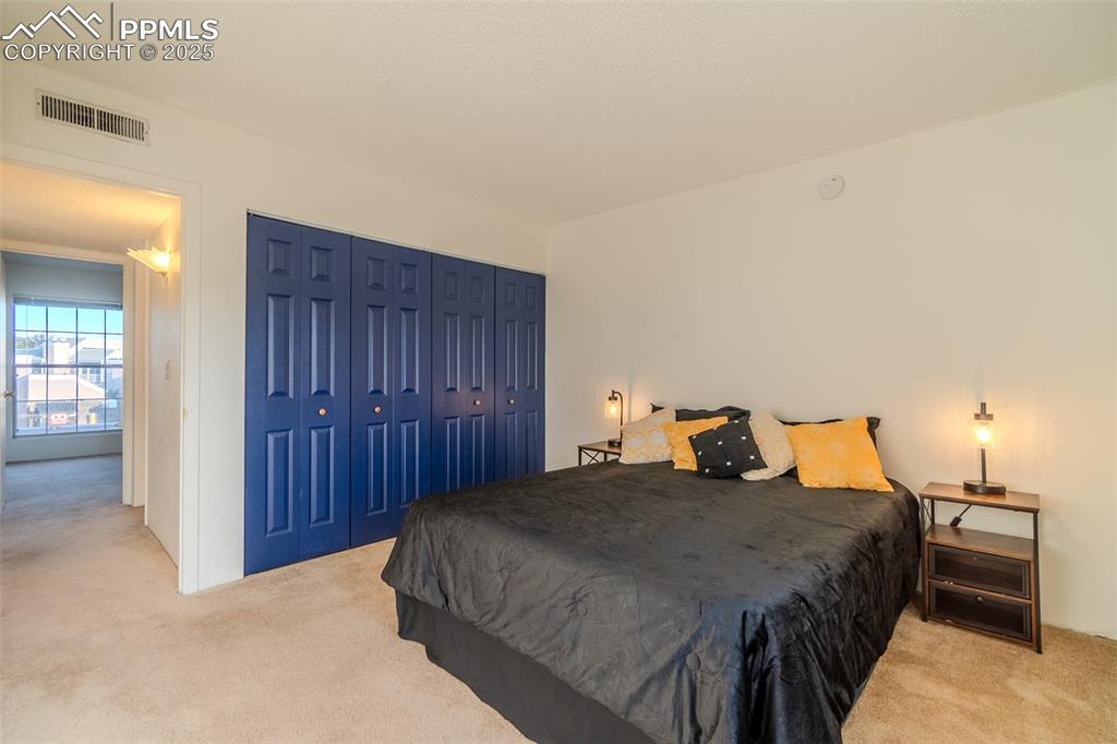 Bedroom featuring carpet and a closet