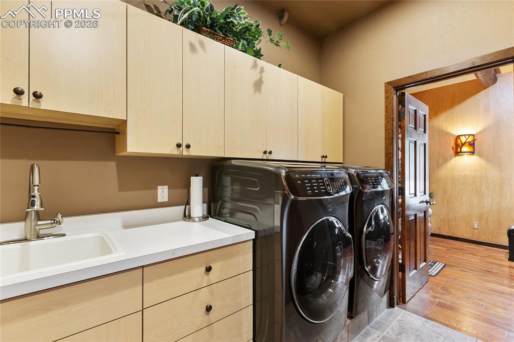 A main level laundry with a sink,  a walk out to the back walkway and a full pantry/storage closet