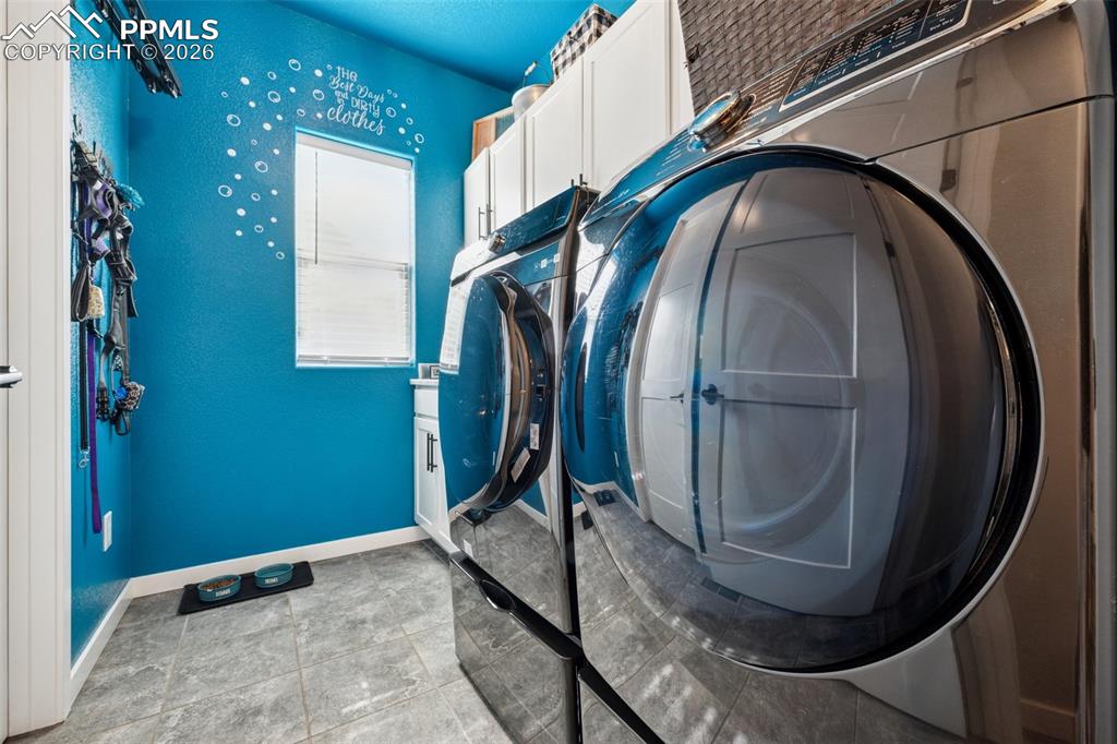 Laundry room featuring cabinet space, sink, washer/dryer included; all on the main level.