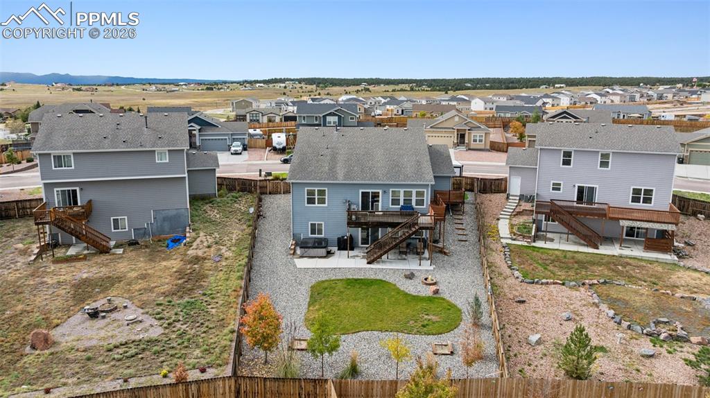 Aerial perspective of quiet suburban area as shown from the rear of the home.