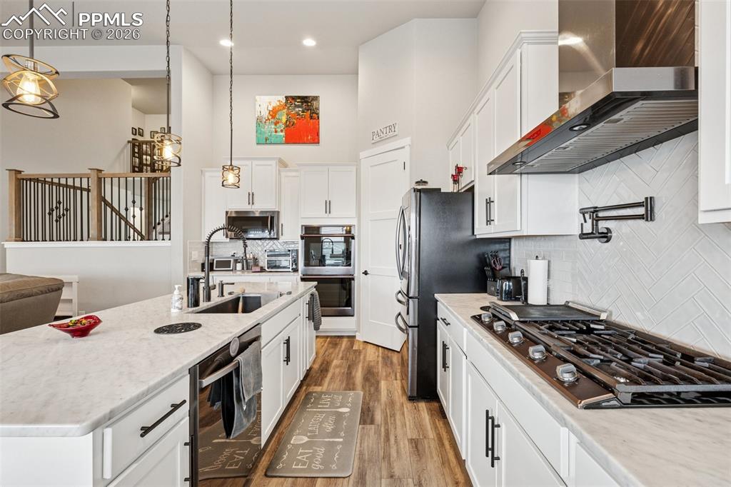 Kitchen is open, conveniently set-up and everyone loves a gas stove with pot filling station.  Tons of upgrades in this space ideal for the pickiest of chefs.