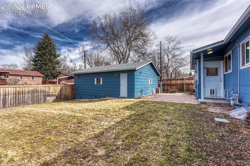 Backyard with a paver patio and oversized detached 2-car garage with a work bench and convenient alley access.