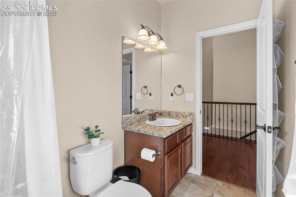 Full bathroom with granite vanity.