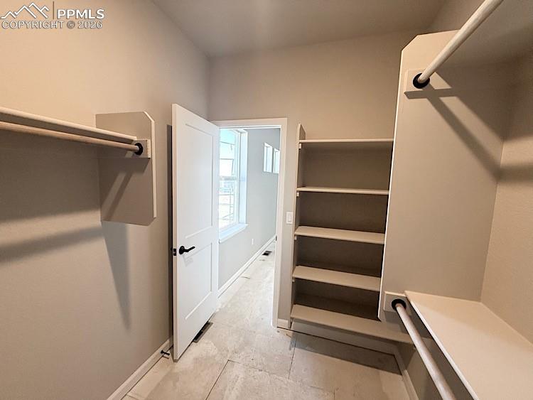 Primary Closet with wood shelving and rods!