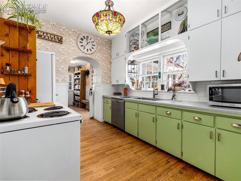 This galley style kitchen with dishwasher, electric range and vintage refrigerator to compliment the vintage style.