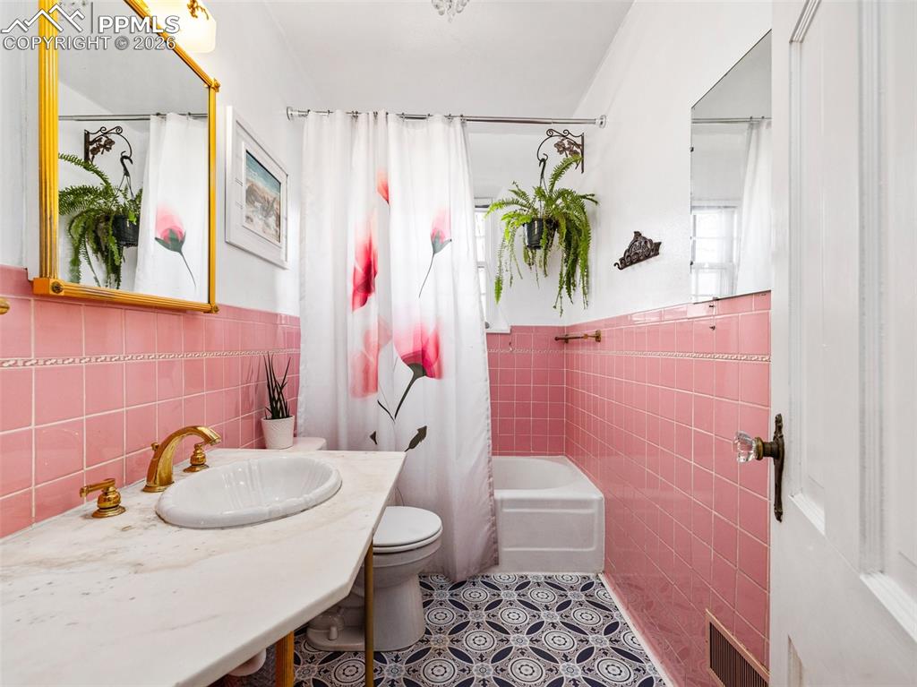 This full bath has new tile flooring and new plumbing