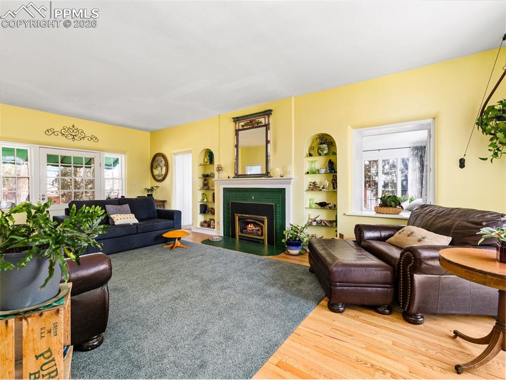 The living room is perfect for family gatherings with the gas fireplace, newly refinished hardwood floors and a floor to ceiling arched window.