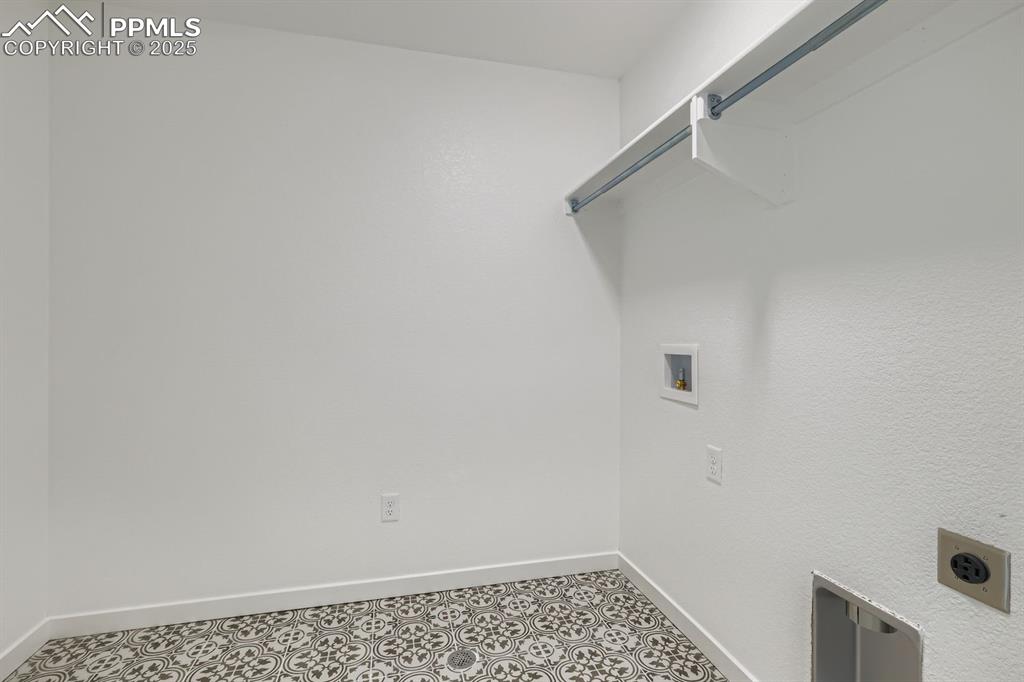 Washroom with baseboards and washer hookup