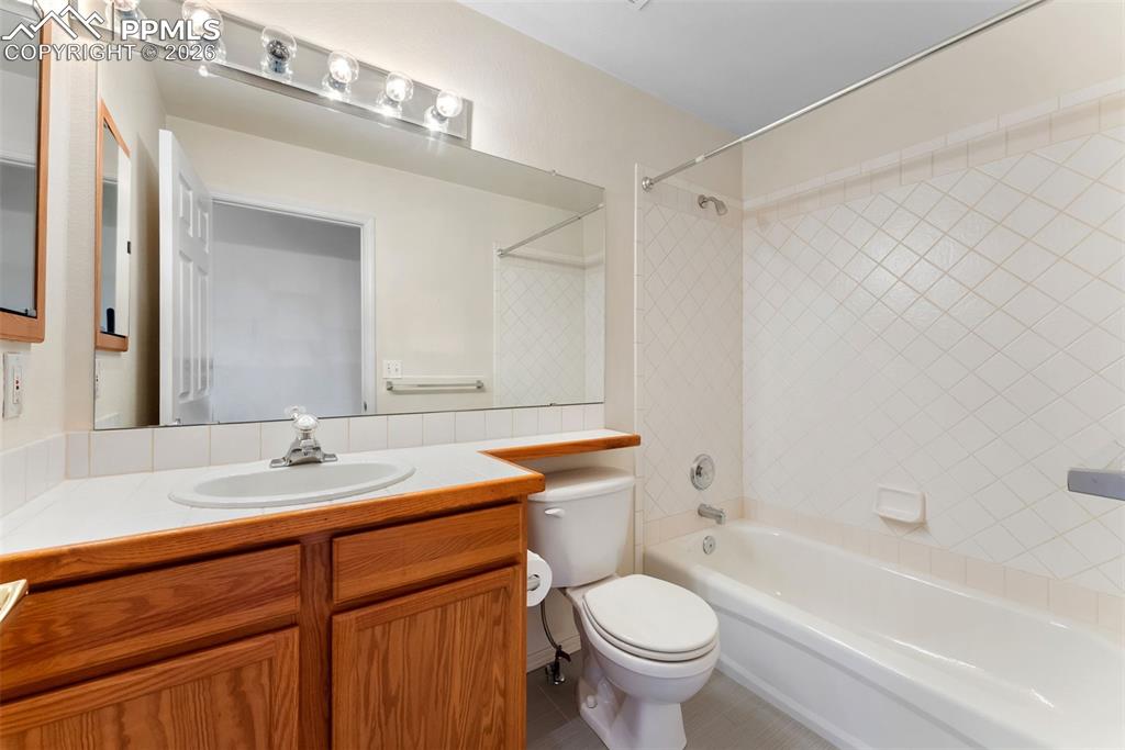 Full bath featuring shower / bath combination and vanity