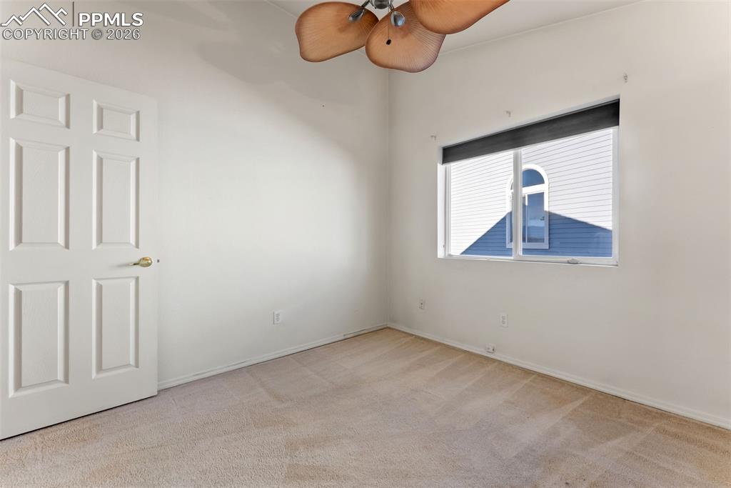 Unfurnished room with light carpet and ceiling fan