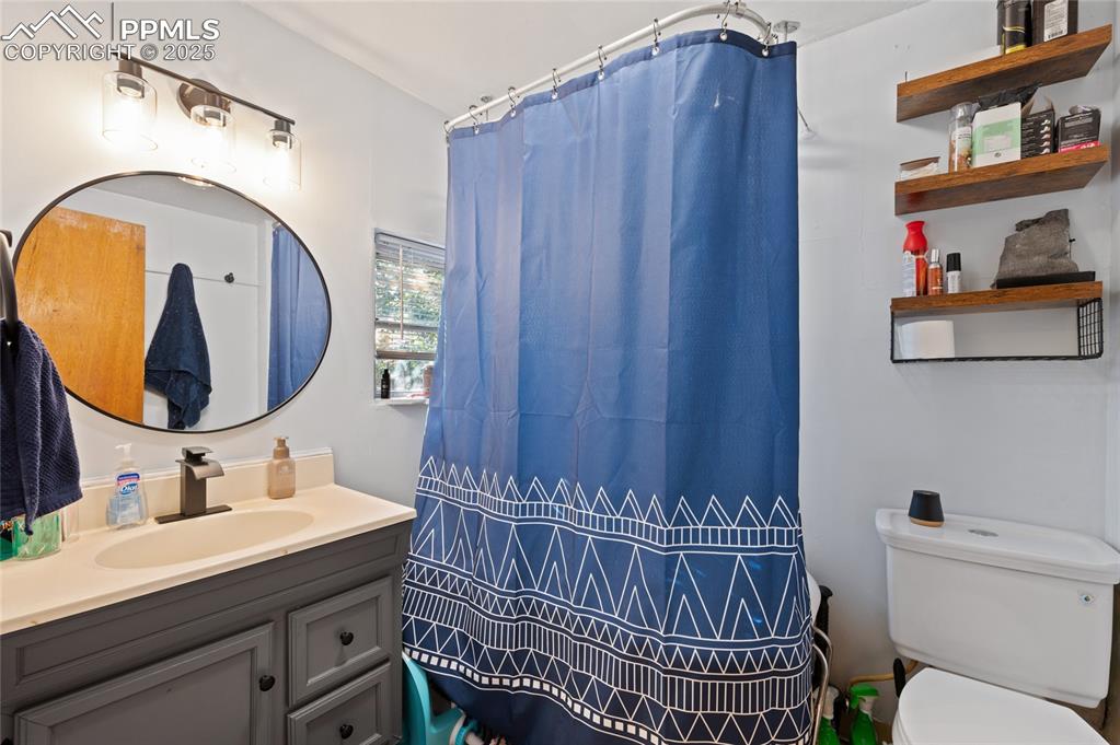 Bathroom with vanity and curtained shower