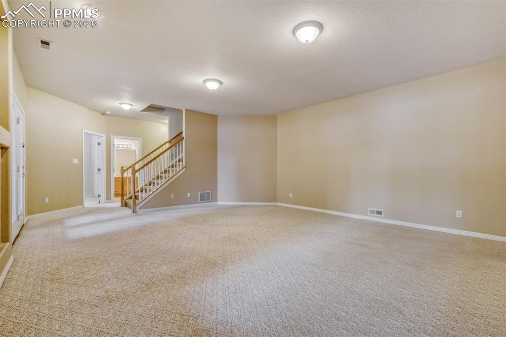 Family room with a tile fireplace and carpet flooring and walkout to covered patio