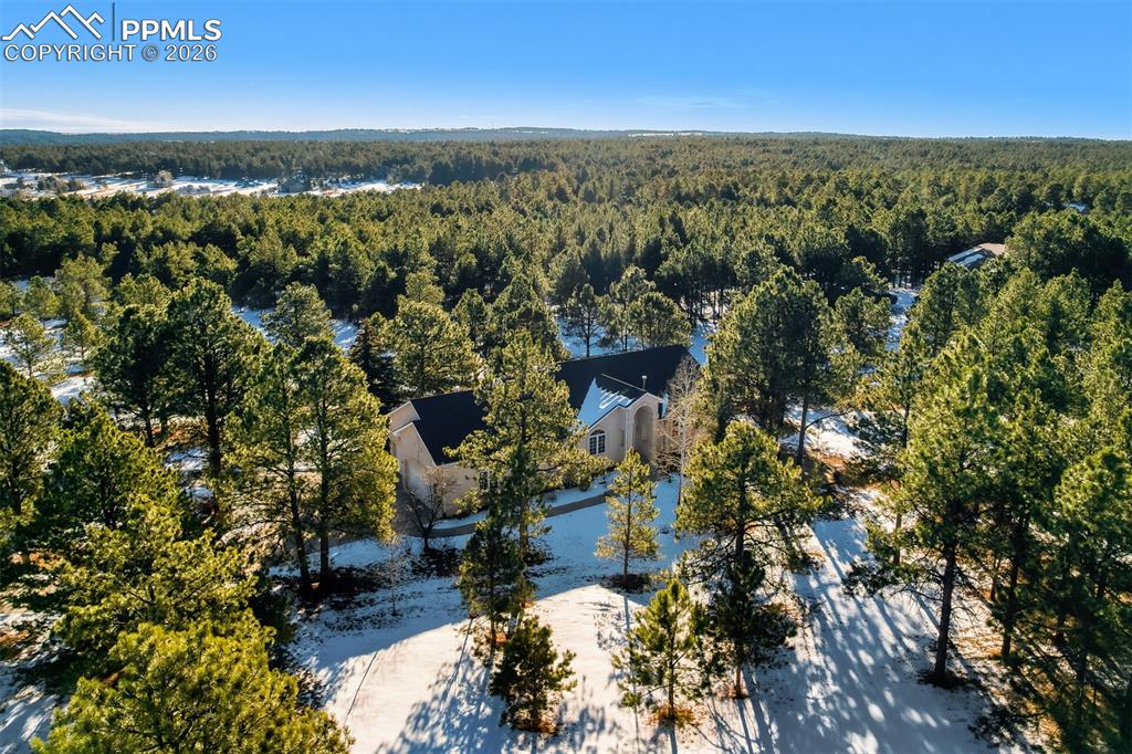 View of subject property with a heavily wooded area